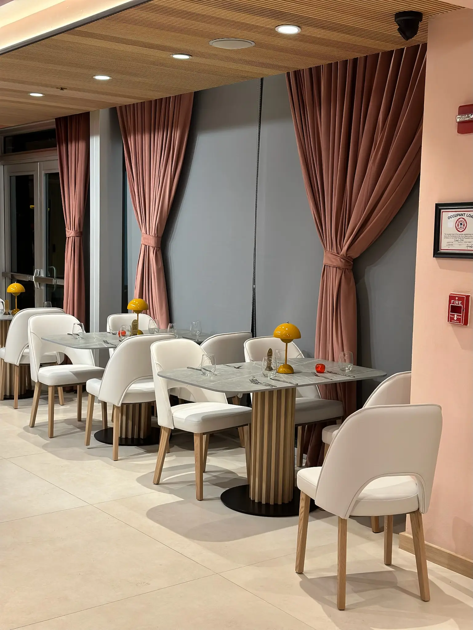 Custom mauve drapes framing a restaurant interior