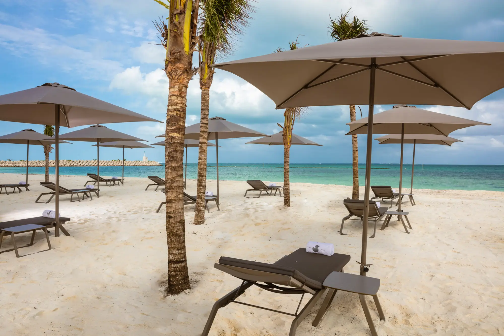 Beachfront resort with rows of parasols and sunbeds