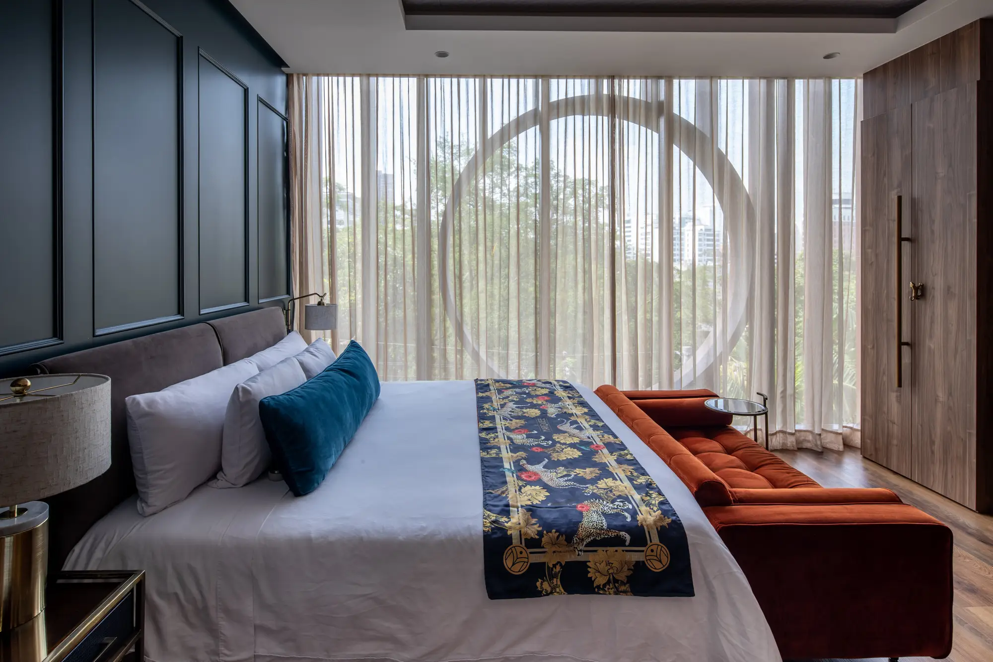 Hotel suite with sheer drapes and a city view