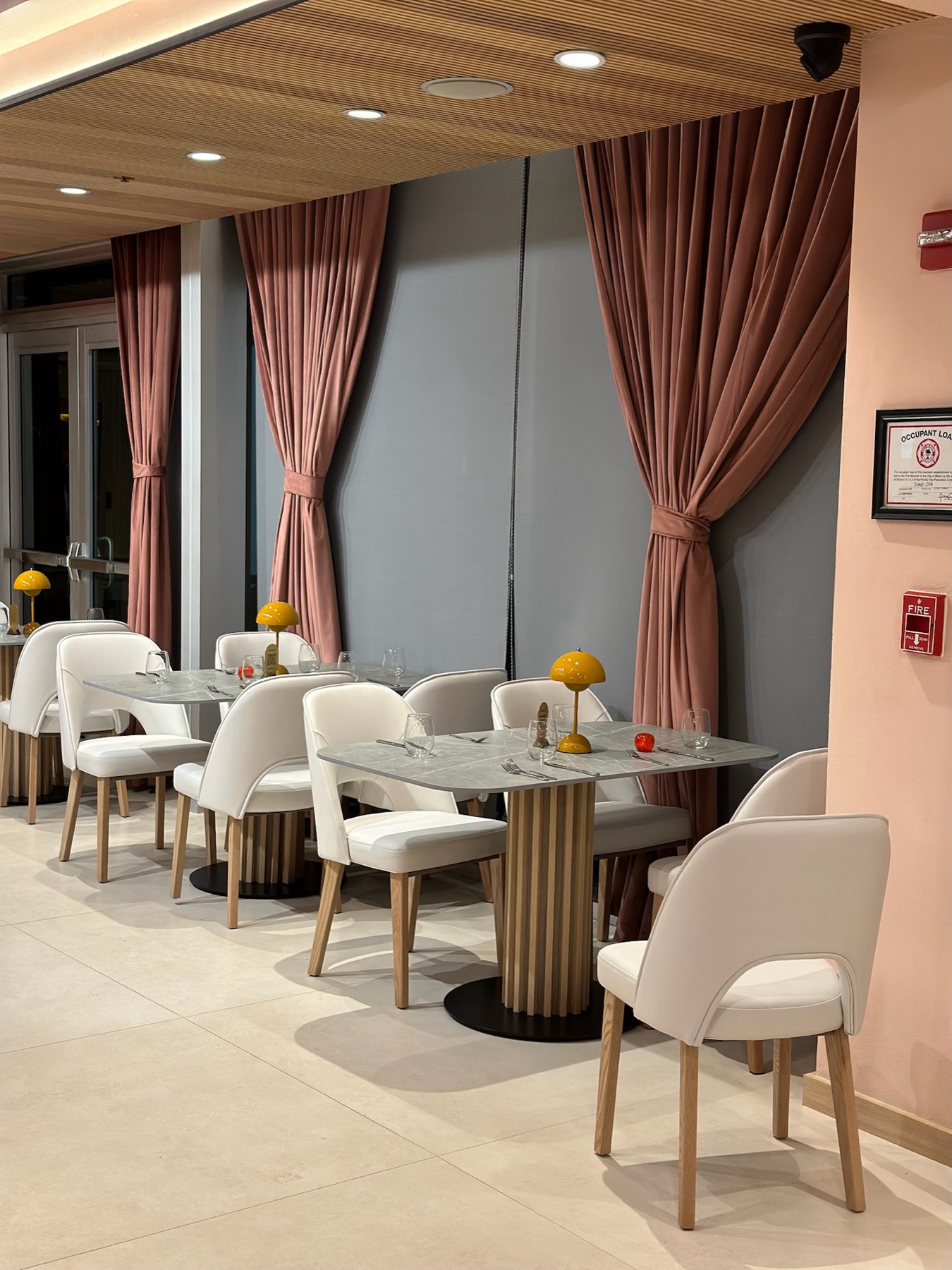 Custom mauve drapes framing a restaurant interior