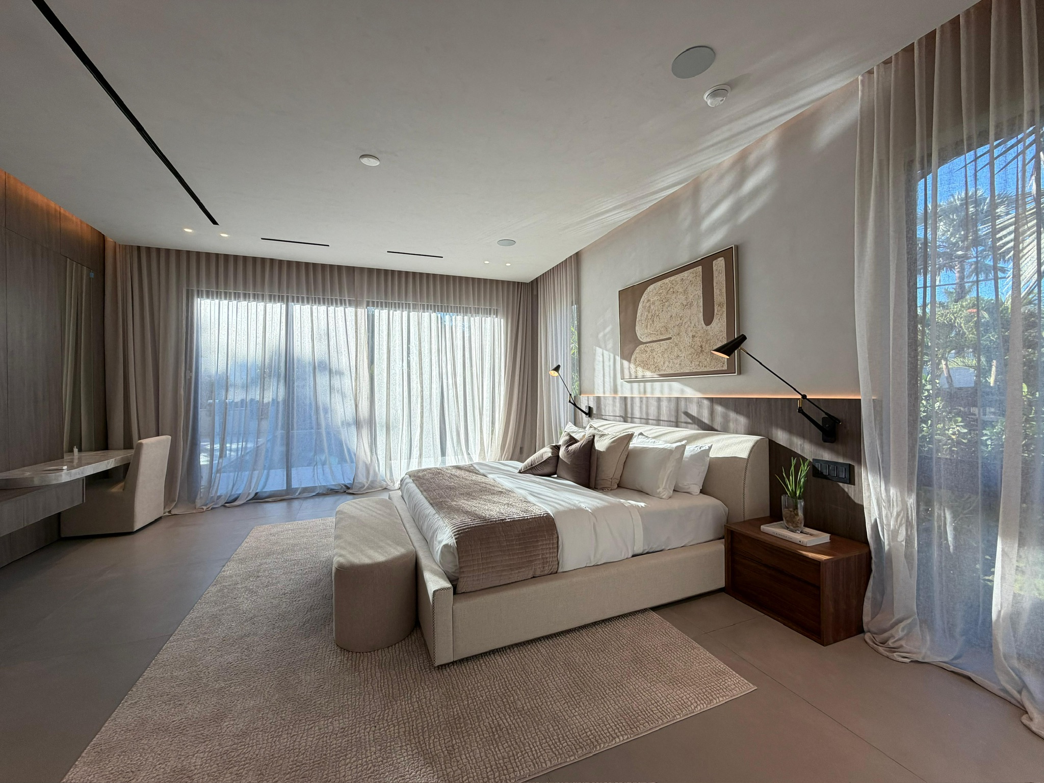 Private master suite framed by full-height custom curtains