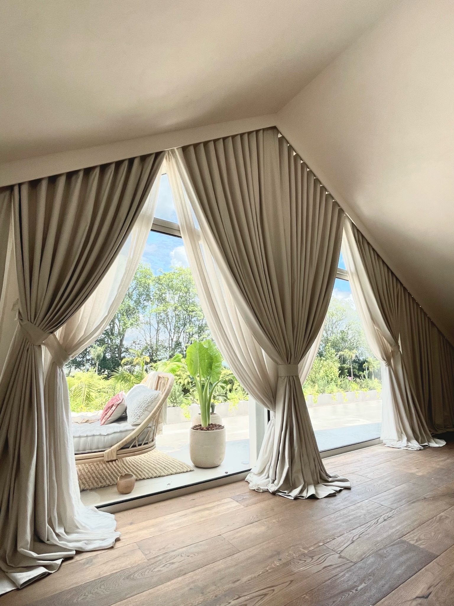 Mezzanine lounge with sculptural pinch-pleat curtains