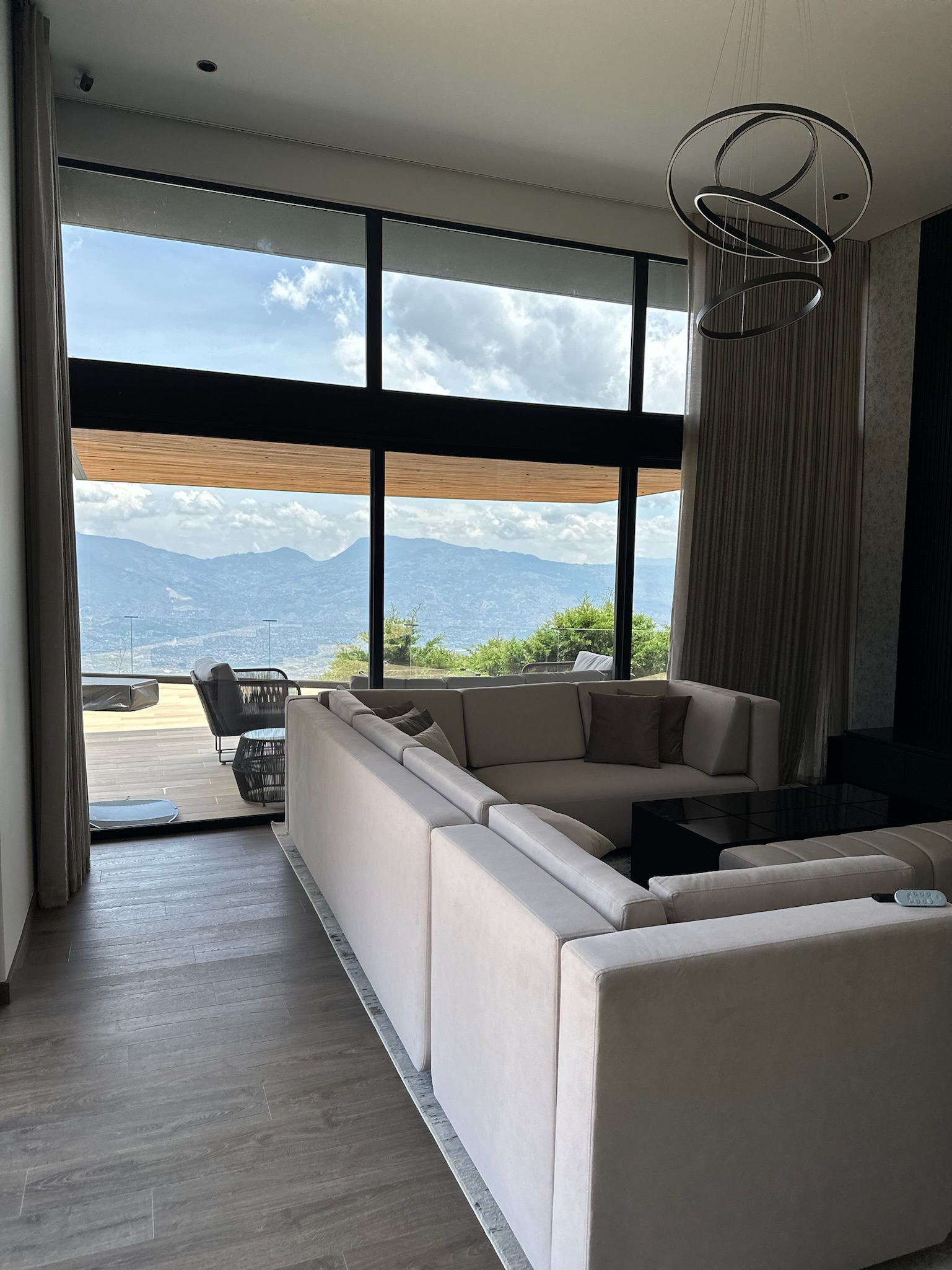 Great room framed by full-height sheer curtains
