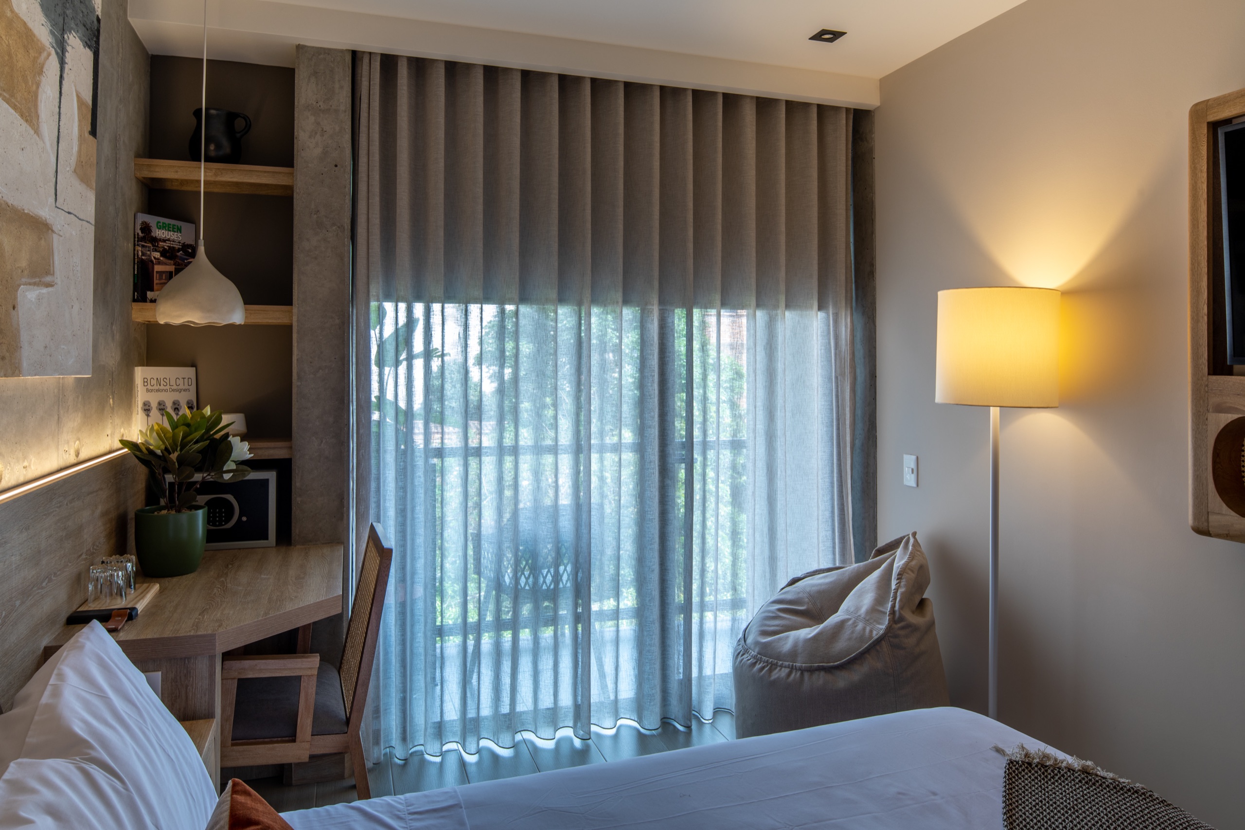 Guest suite with layered sheer and blackout curtains