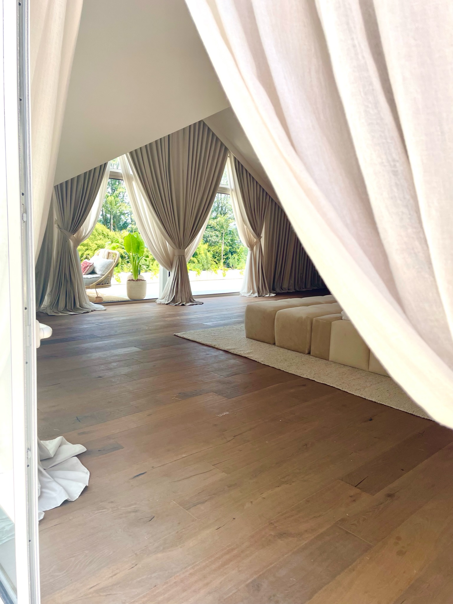 Custom sheer curtains framing a private Miami terrace at golden hour