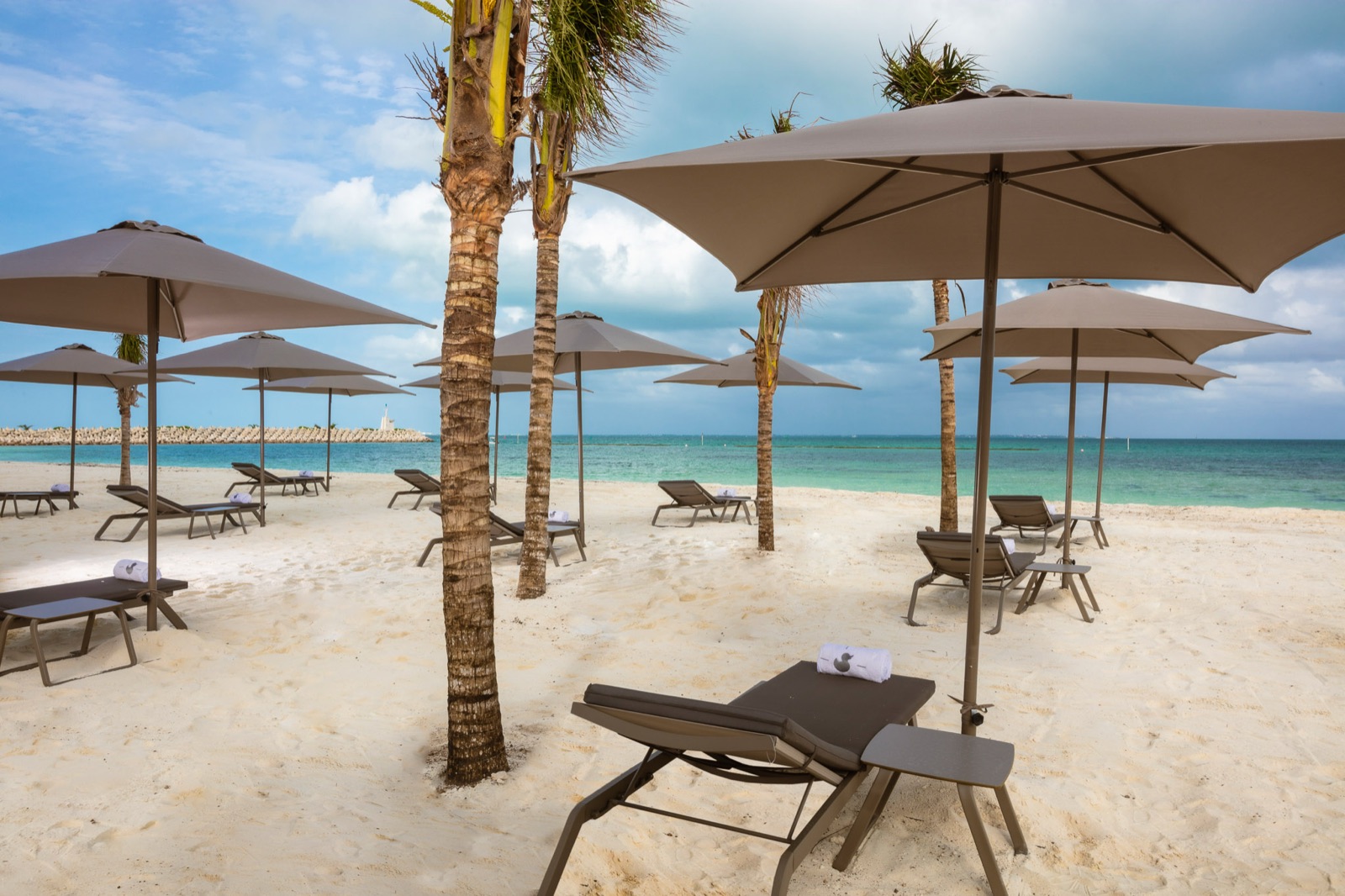 Beachfront resort with rows of parasols and sunbeds
