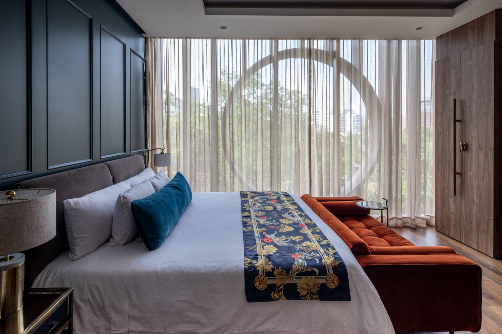 Hotel suite with sheer drapes and a city view